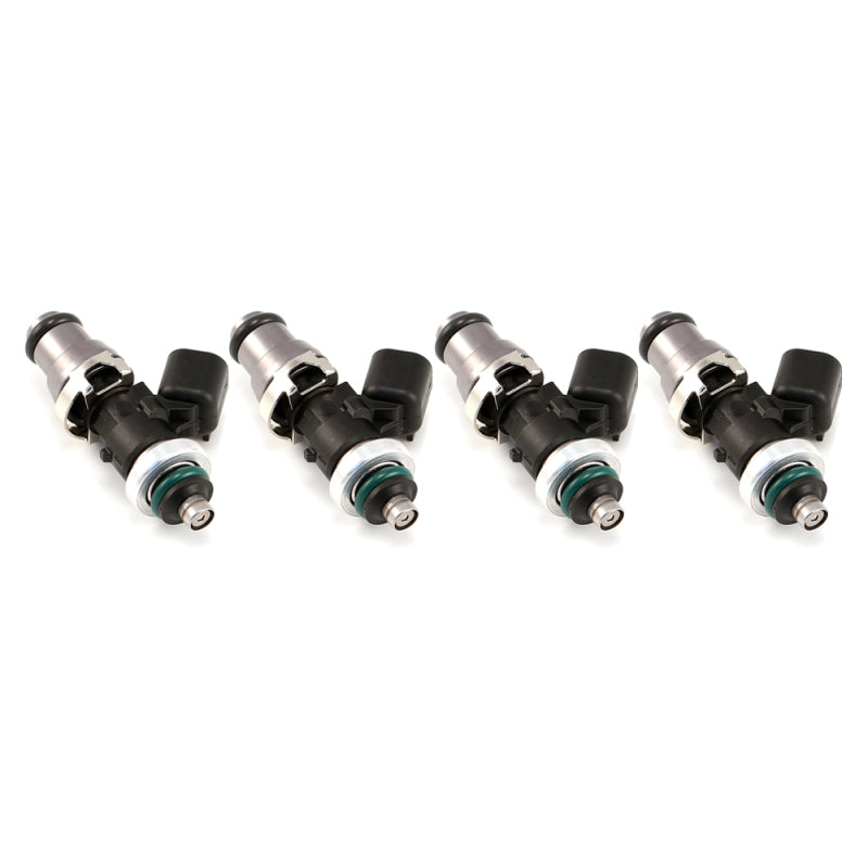 Injector Dynamics ID1050X fuel injectors, set of four, side view showing electrical connectors and green O-rings.