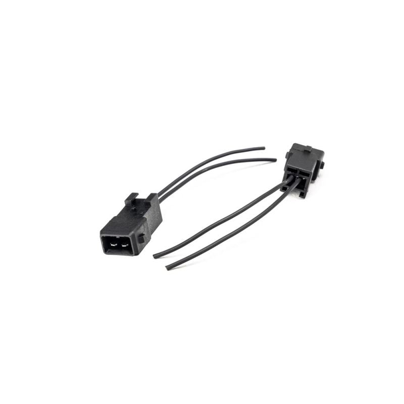 Injector Dynamics EV1 male connector kit pigtail, two black plugs with short wire leads on white background