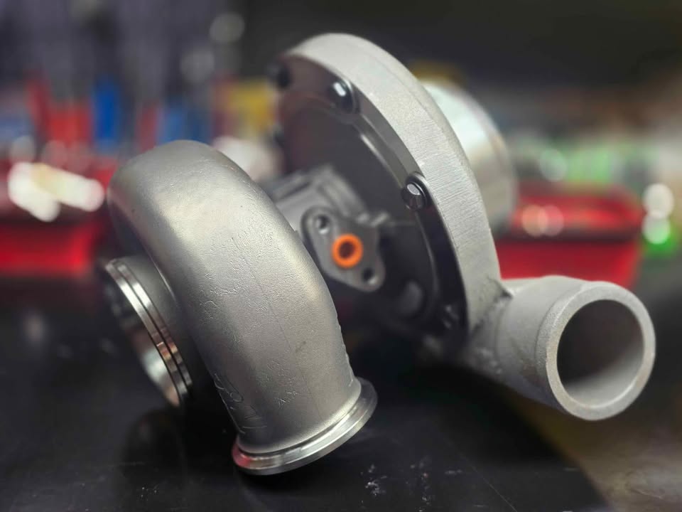 BW S364.5 SXE turbo with Tial housing, front angle showing compressor and turbine housings, orange sensor plug visible