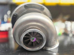 BorgWarner S364.5 SXE turbo with Tial housing, front view showing compressor wheel and inlet flange.