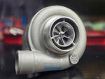 BW S364.5 SXE turbo with Tial housing, front angle showing compressor wheel and cast inlet elbow