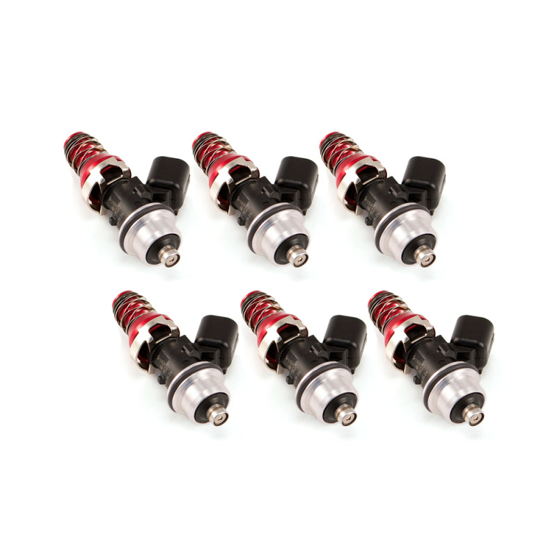 Set of six Injector Dynamics ID1050X fuel injectors with red 11mm adaptors, S2K lower fittings, top angled view
