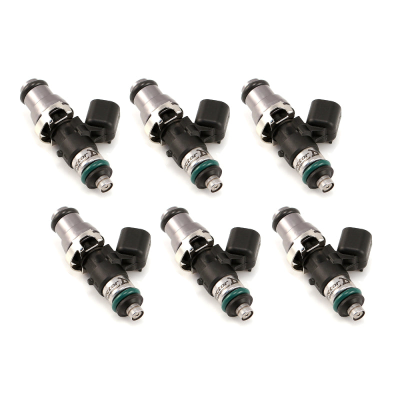 Set of six Injector Dynamics 1340cc fuel injectors, angled view showing grey tops and lower O-rings, connectors facing left.