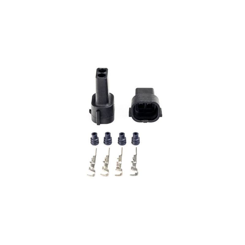 Injector Dynamics Denso male connector kit, two black housings, four terminal pins and seals below