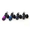 Six Injector Dynamics ID1050X injectors standing upright, blue and purple tops, black nozzles with O-rings visible