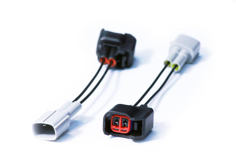 Injector Dynamics USCAR to Toyota PNP adaptor pair, black and white connectors with wire leads