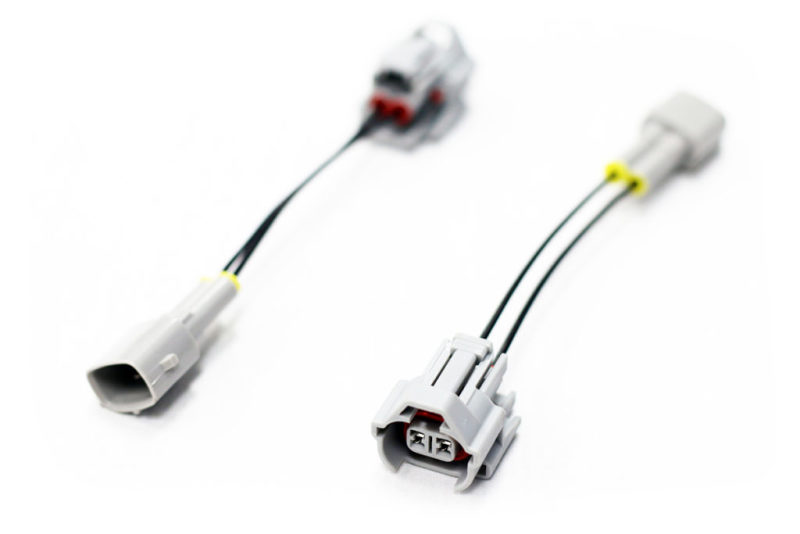 Injector Dynamics Denso to 2000+ Toyota PNP adaptor, two wiring harnesses with connectors on white background