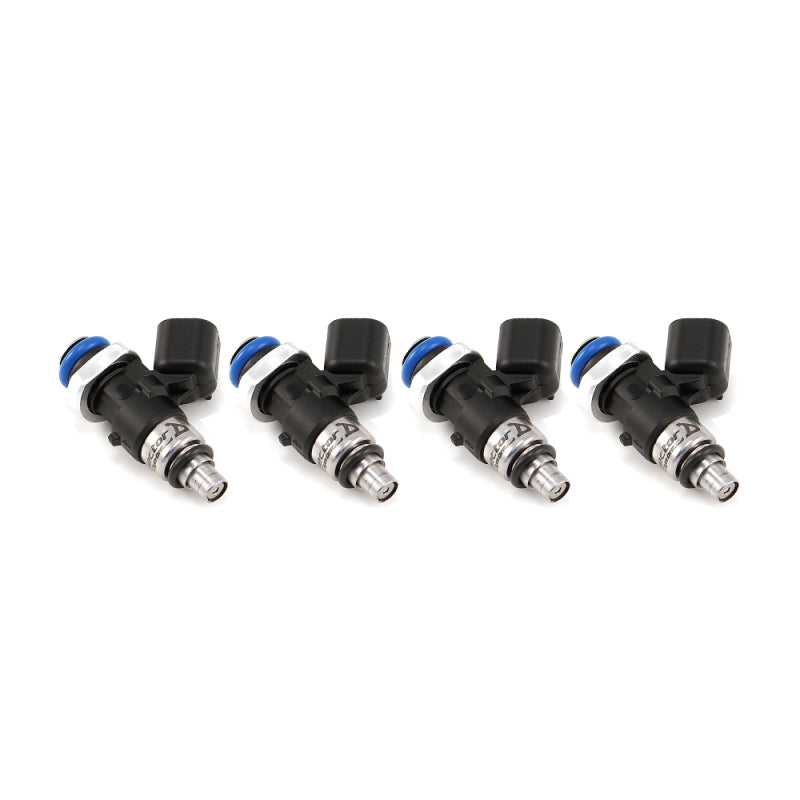 Set of four Injector Dynamics ID1050X fuel injectors, angled view showing blue top seals and connectors