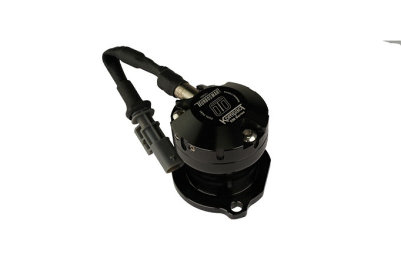 Turbosmart Kompact EM VR7 dual port BOV, top angle view showing black solenoid, wiring harness and connector, and mounting flange.