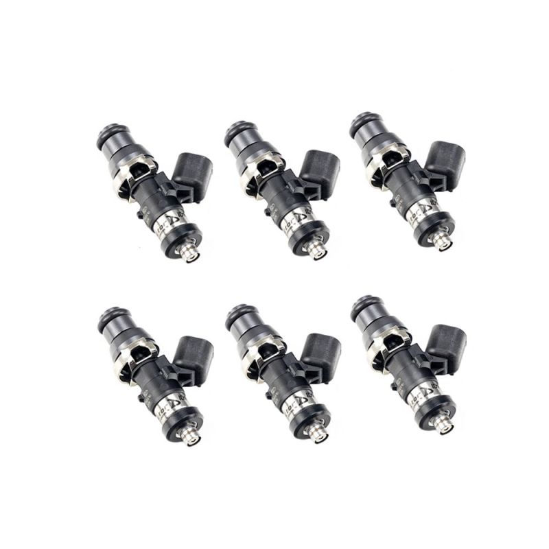 Set of six Injector Dynamics ID1050X fuel injectors, angled view showing top connectors and lower nozzle tips.