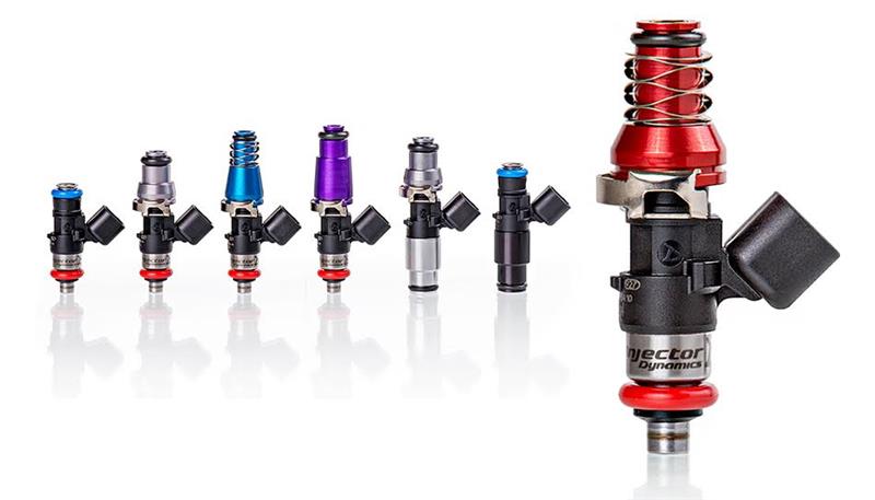 Injector Dynamics ID1050X fuel injectors, six colored bodies beside one large red topped injector, front view
