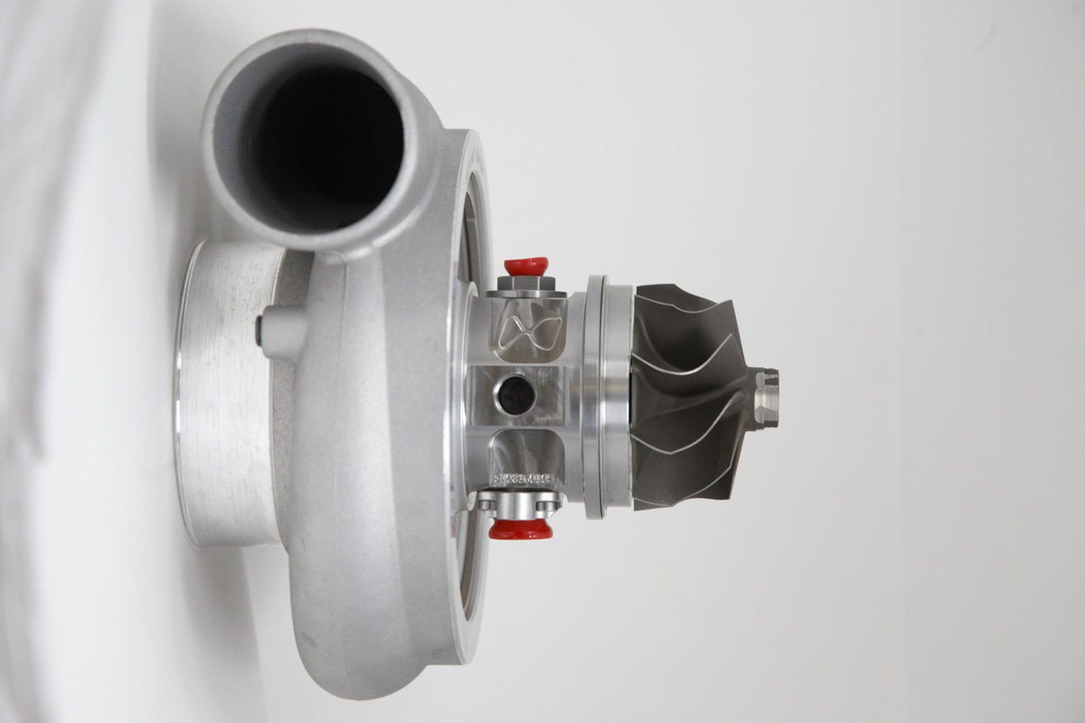 Xona Rotor 78-65 X3C turbo, side angle showing compressor wheel, wastegate, and housing ports