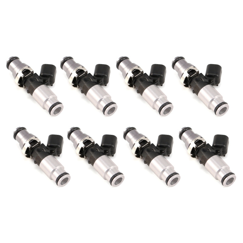 Set of 8 Injector Dynamics 1340cc fuel injectors, silver bodies, black electrical connectors, angled view.