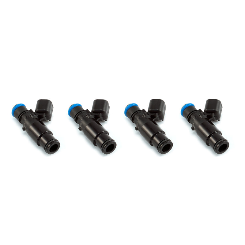 Set of four Injector Dynamics 1340cc fuel injectors, angled view showing black bodies and blue upper seals