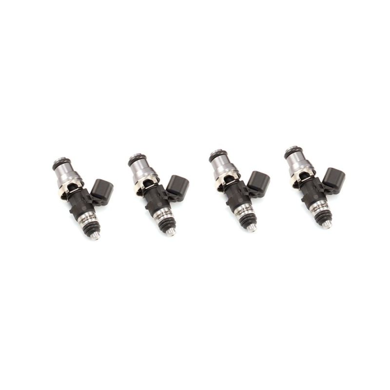 Set of four Injector Dynamics 1050cc fuel injectors, angled view showing electrical connectors and lower nozzle tips