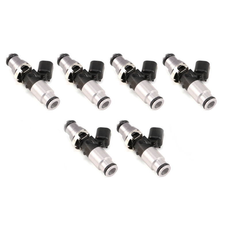 Set of six Injector Dynamics ID1300X fuel injectors for Audi/VW VR6, silver bodies with black top connectors, angled view
