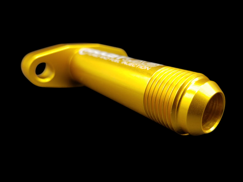 Gold billet T3/T4 extended turbo oil drain flange with -10 AN threaded fitting, angled view showing mounting hole and bolt pattern