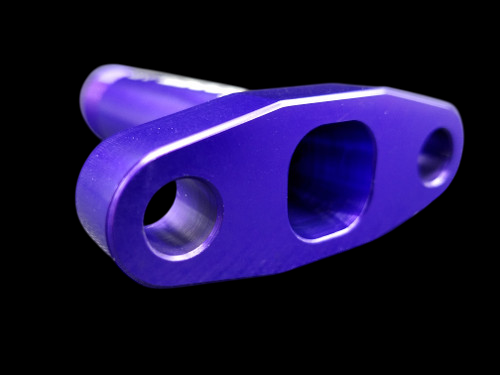 Purple anodized billet T3/T4 turbo oil drain flange, angled view showing three mounting holes.