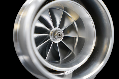 Close up front view of the BL6662X billet turbocharger compressor wheel, showing polished curved blades and hub.