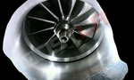 BL372R with Race Cover turbo compressor wheel, close up front view showing curved milled blades and center shaft nut