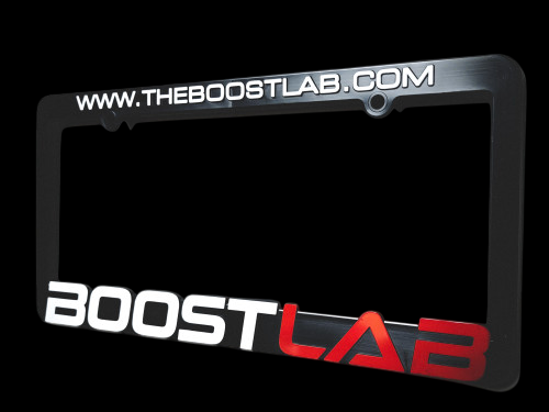 Boost Lab license plate frame, angled view, www.theboostlab.com text on top, Boost Lab logo on bottom rail