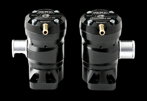 GFB Mach 2 TMS diverter valves, pair shown side by side, black billet housings with silver inlet fittings and brass nipples visible.