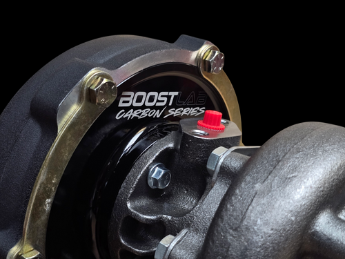 BL5757C Carbon Series turbocharger, close up of compressor housing with gold V band clamp and oil fitting