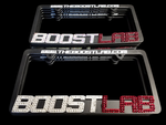Two Boost Lab crystallized license plate frames stacked, showing BOOSTLAB in clear and red rhinestones.